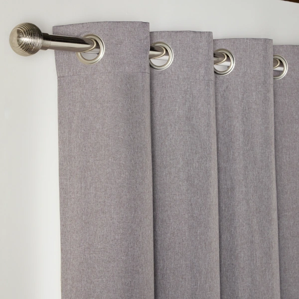 Close-up of grey eyelet curtains on a silver rod