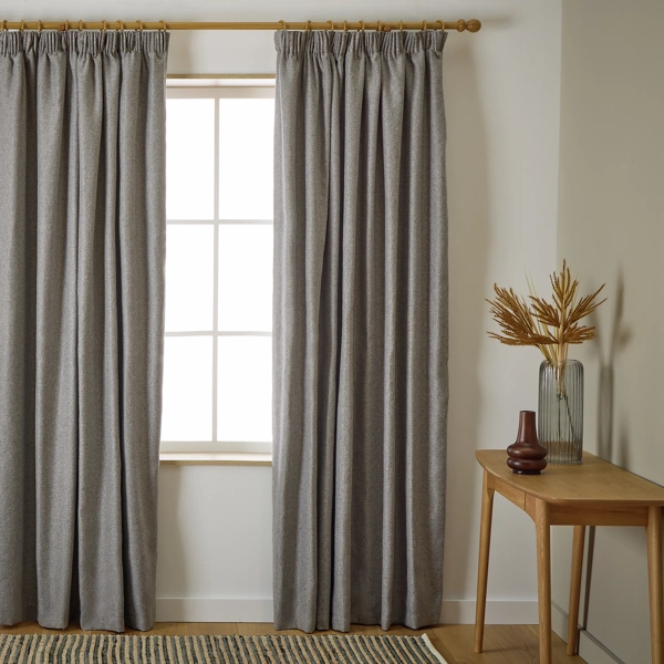 Full view of grey curtains in a bright room