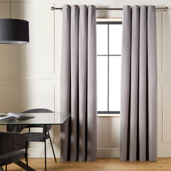 Grey floor-length curtains in a modern dining room